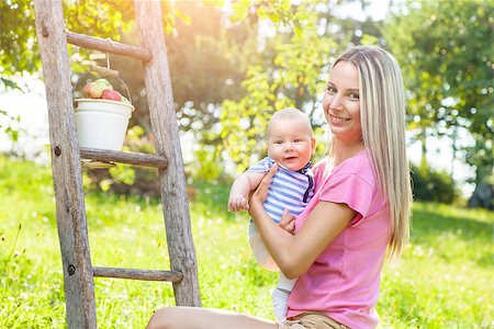 family apple orchard - Mother with her baby picking apples from an apple tree Stock Photo - Budget Royalty-Free & Subscription, Code: 400-08790263