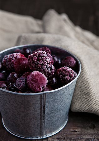 Frozen berries mix in a black bowl on wooden background. Still life photography Stock Photo - Budget Royalty-Free & Subscription, Code: 400-08791408