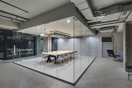 empty room with glass door - Luminous conference zone in the office in a loft style with brick walls and concrete columns. Zone has a large wooden table with gray chairs and glass walls. Above the table there is a projector. Stock Photo - Budget Royalty-Free & Subscription, Code: 400-08793642