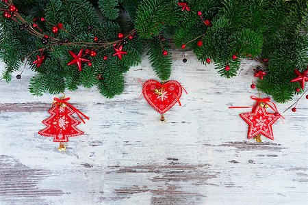 christmas fresh evergreen tree branches with red vintage heart, christas tree and star decorations on white aged wood Stock Photo - Budget Royalty-Free & Subscription, Code: 400-08808042