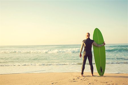 silhouettes surfboards in the sand - Surfer on the beach holding is surfboaerd and watching the waves Stock Photo - Budget Royalty-Free & Subscription, Code: 400-08809444