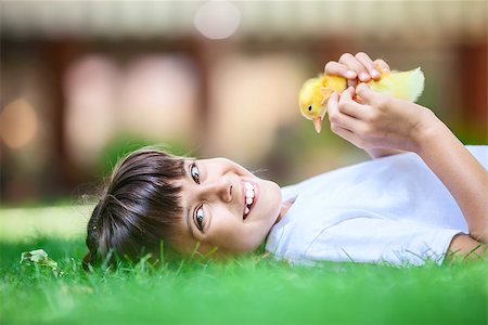 Little girl with a spring duckling Stock Photo - Budget Royalty-Free & Subscription, Code: 400-08811833
