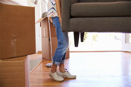 Close Up Of Woman Carrying Sofa Into New Home On Moving Day Stock Photo - Budget Royalty-Free & Subscription, Code: 400-08838409