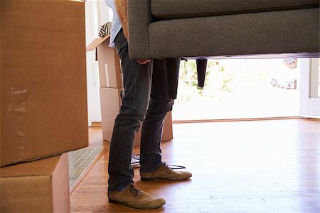 Close Up Of Man Carrying Sofa Into New Home On Moving Day Stock Photo - Budget Royalty-Free & Subscription, Code: 400-08838410