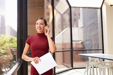 Smiling young white businesswoman on phone in modern office Stock Photo - Budget Royalty-Free & Subscription, Code: 400-08838783