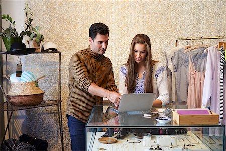 Young man and woman working together in clothes shop Stock Photo - Budget Royalty-Free & Subscription, Code: 400-08839010