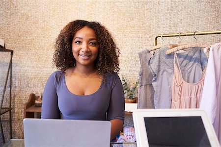 Mixed race sales assistant at the counter of clothing store Stock Photo - Budget Royalty-Free & Subscription, Code: 400-08839102