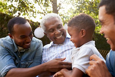 Black grandfather, sons and grandson talking in a garden Stock Photo - Budget Royalty-Free & Subscription, Code: 400-08839210