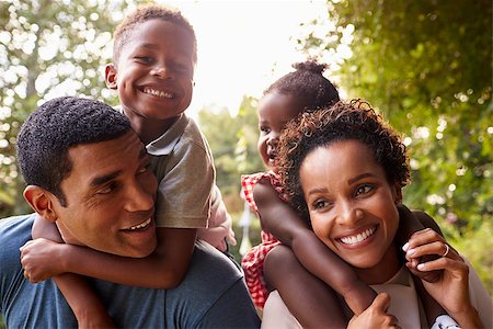 African American parents giving children piggyback rides Stock Photo - Budget Royalty-Free & Subscription, Code: 400-08839234