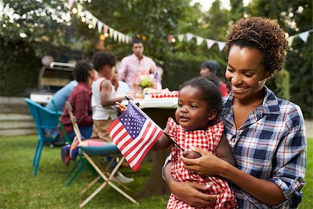 Black mother and baby holding flag at 4th July garden party Stock Photo - Budget Royalty-Free & Subscription, Code: 400-08839248