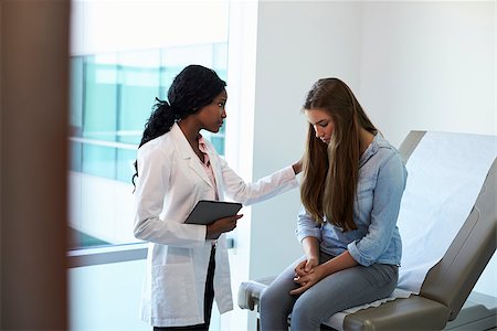 Doctor Talking To Unhappy Teenage Patient In Exam Room Stock Photo - Budget Royalty-Free & Subscription, Code: 400-08839460