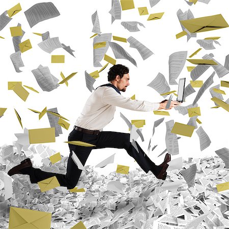 running away scared - Businessman with laptop runs away from a paperwork and bureaucracy Stock Photo - Budget Royalty-Free & Subscription, Code: 400-08830920