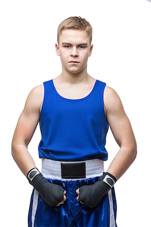 Young handsome boxer sportsman in blue boxer suit and black gloves standing on white backgound. Isolated. Copy space. Stock Photo - Budget Royalty-Free & Subscription, Code: 400-08888254