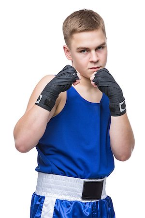 Young handsome boxer sportsman in blue boxer suit and black wrist wraps standing on white backgound. Isolated. Copy space. Stock Photo - Budget Royalty-Free & Subscription, Code: 400-08888255