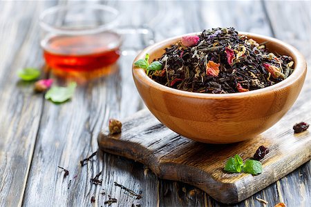 Bowl of tea with flower petals and cup of hot tea on old wooden table, selective focus. Stock Photo - Budget Royalty-Free & Subscription, Code: 400-08899209