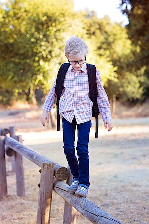 simsearch:695-03381153,k - adorable little schoolboy with backpack being playful in the park ready for school year, back to school concept Stock Photo - Budget Royalty-Free & Subscription, Code: 400-08893686