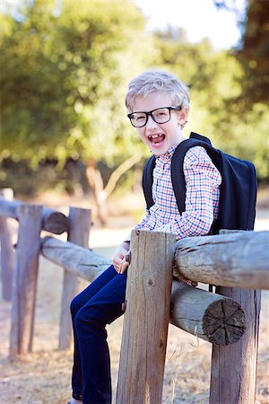 simsearch:695-03381153,k - smiling little schoolboy with backpack being playful in the park ready for school year, back to school concept Stock Photo - Budget Royalty-Free & Subscription, Code: 400-08893687