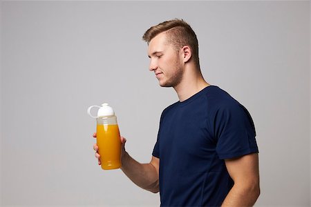 Studio Portrait Of Male Nutritionist With Drinks Bottle Stock Photo - Budget Royalty-Free & Subscription, Code: 400-08938112