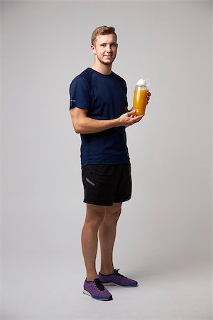 Studio Portrait Of Male Nutritionist With Drinks Bottle Stock Photo - Budget Royalty-Free & Subscription, Code: 400-08938113