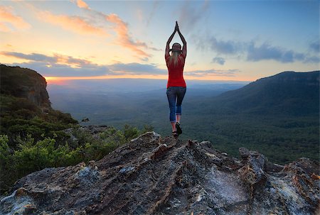 Arms outstretched,  reach for the sky. Stand on tippy toes, oh,oh,so high.  Woman on the edge of a mountain cliff with valley views stretches her arms toward the sky. Stock Photo - Budget Royalty-Free & Subscription, Code: 400-09008752