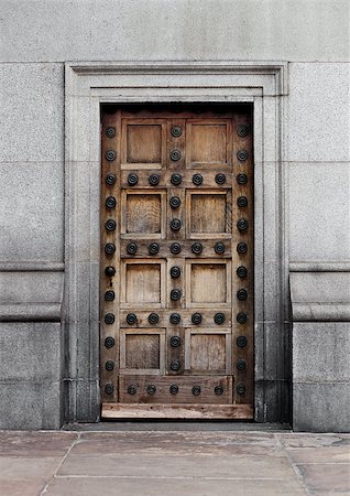 simsearch:400-07257534,k - Old wooden door with steel lock and decoration build in concrete building Stock Photo - Budget Royalty-Free & Subscription, Code: 400-09019498