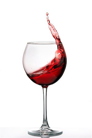 simsearch:400-04226436,k - Glass with a splash of red wine isolated on white background. Clarity wineglass and wine. Aesthetics and delight. Relaxation. Luxury. Stock Photo - Budget Royalty-Free & Subscription, Code: 400-09028428