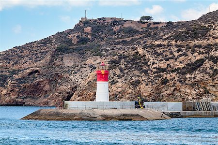 simsearch:400-04272525,k - Red and white lighthouse near the fort of Christmas and the seaport. Cartagena, Spain Stock Photo - Budget Royalty-Free & Subscription, Code: 400-09028818