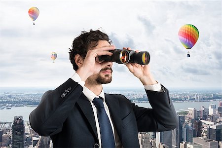 Businessman looks at the city from the roof with binoculars Stock Photo - Budget Royalty-Free & Subscription, Code: 400-09028896
