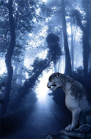simsearch:400-05716374,k - Mysterious landscape with ancient lion statue, road and trees in foggy forest Stock Photo - Budget Royalty-Free & Subscription, Code: 400-09029534