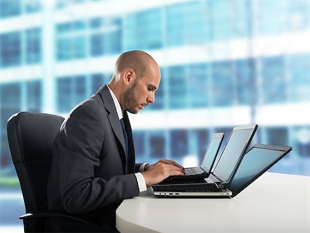 past due - Tired businessman works with three laptop in the office Stock Photo - Budget Royalty-Free & Subscription, Code: 400-09029641