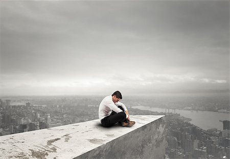 discharge - Alone desperate businessman sits on a roof. solitude and failure concept Stock Photo - Budget Royalty-Free & Subscription, Code: 400-09029665