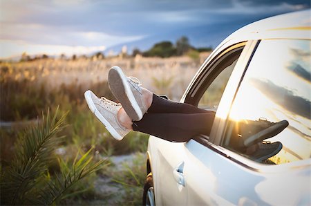 funny driver photos - Women's legs out of car window on nature background Stock Photo - Budget Royalty-Free & Subscription, Code: 400-09065204