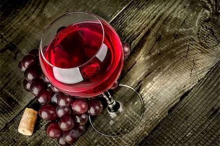 simsearch:400-04226436,k - Glass of red wine with grapes on a wooden table Stock Photo - Budget Royalty-Free & Subscription, Code: 400-09066974