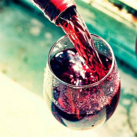 simsearch:400-04226436,k - pouring red wine. Wine in a glass, selective focus, motion blur, Red wine in a glass. Sommelier pouring the wine into the glass. Thanksgiving Day, Valentine's day, date, love, Celebration. Stock Photo - Budget Royalty-Free & Subscription, Code: 400-09069095