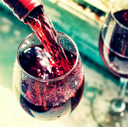 simsearch:400-04226436,k - pouring red wine. Wine in a glass, selective focus, motion blur, Red wine in a glass. Sommelier pouring the wine into the glass. Thanksgiving Day, Valentine's day, date, love, Celebration. Stock Photo - Budget Royalty-Free & Subscription, Code: 400-09069097