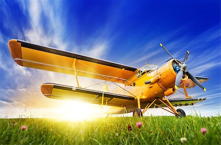 simsearch:400-08188604,k - historic biplane on a meadow against a sunset Stock Photo - Budget Royalty-Free & Subscription, Code: 400-09084970