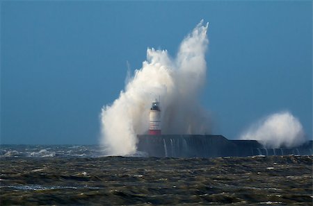 Breaking wave over Newhaven Lighthouse in East Sussex, with Gull against white wave and rough sea. Stock Photo - Budget Royalty-Free & Subscription, Code: 400-09097047