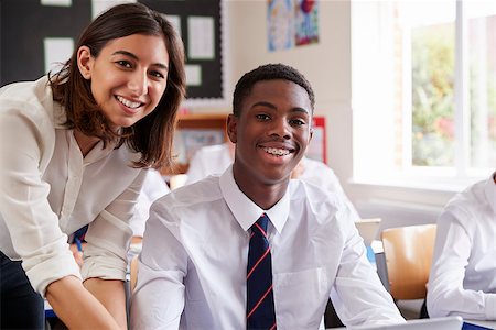 Portrait Of Teacher Helping Pupil Using Computer In Classroom Stock Photo - Budget Royalty-Free & Subscription, Code: 400-09122010