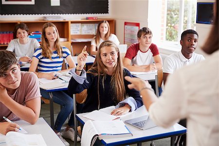 Female Student Raising Hand To Ask Question In Classroom Stock Photo - Budget Royalty-Free & Subscription, Code: 400-09122025