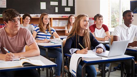 Students Listening To Female Teacher In Classroom Stock Photo - Budget Royalty-Free & Subscription, Code: 400-09122023