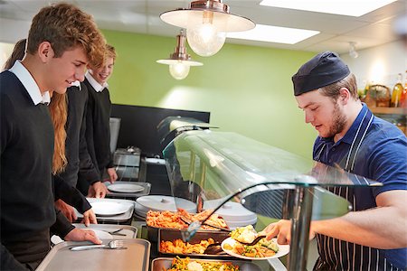 Teenage Students Being Served Meal In School Canteen Stock Photo - Budget Royalty-Free & Subscription, Code: 400-09122078