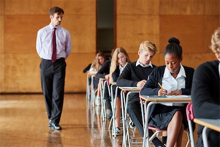 Teenage Students Sitting Examination With Teacher Invigilating Stock Photo - Budget Royalty-Free & Subscription, Code: 400-09122102