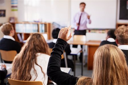Female Student Raising Hand To Ask Question In Classroom Stock Photo - Budget Royalty-Free & Subscription, Code: 400-09122120