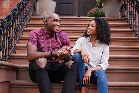 Couple Sit And Talk On Stoop Of Brownstone In New York City Stock Photo - Budget Royalty-Free & Subscription, Code: 400-09122656