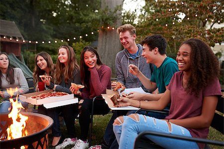 Teenagers at a fire pit eating take-away pizzas, close up Stock Photo - Budget Royalty-Free & Subscription, Code: 400-09123054