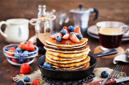 Stack of freshly prepared banana  pancakes with fresh berries and maple syrup for breakfast Stock Photo - Budget Royalty-Free & Subscription, Code: 400-09132271