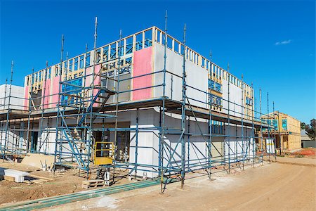 construction of a new housing estate, new homes in the scaffolding in the process of construction phase Stock Photo - Budget Royalty-Free & Subscription, Code: 400-09140789
