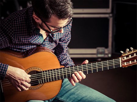 sumners (artist) - Photo of a man playing his acoustic guitar in a rehearsal studio. Focus on manâ??s head. Stock Photo - Budget Royalty-Free & Subscription, Code: 400-09140816