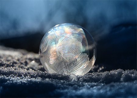 Frozen soap bubble ball on cold winter snow, crystal formations, dark background Stock Photo - Budget Royalty-Free & Subscription, Code: 400-09151312