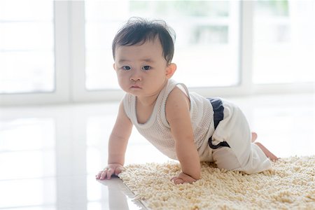 simsearch:400-07171482,k - Chinese baby boy crawling on carpet. Asian family at home, living lifestyle indoors. Stock Photo - Budget Royalty-Free & Subscription, Code: 400-09151677